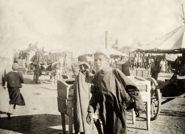 North African boys at an outdoor bazaar. Two north African boys, pictured at an outdoor bazaar.