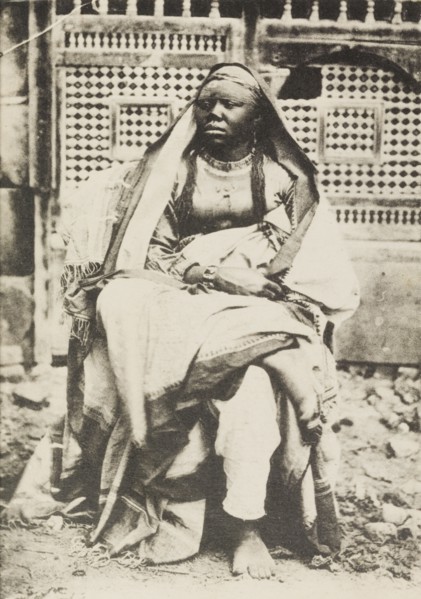 Portrait of an African woman in Egypt. Portrait of an African woman, sitting cross-legged on a