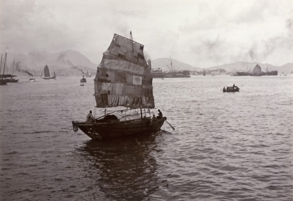 Sampan with a patchwork sail. A Chinese sampan, fitted with a distinctive patchwork sail, sails in