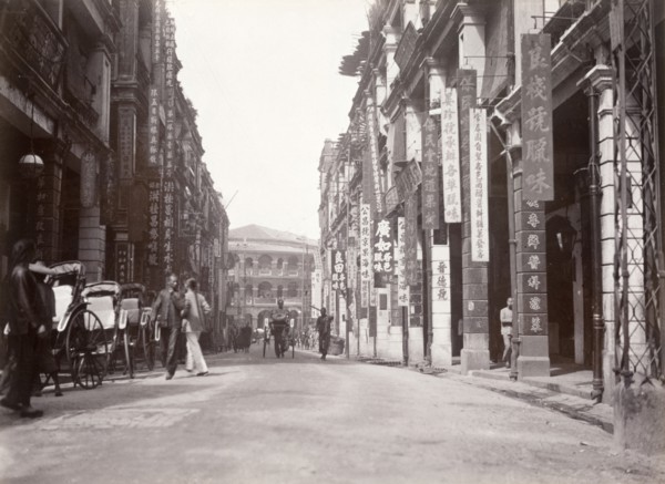 Queen's Road west, Hong Kong. Rickshaw drivers wait for passing business on Queen's Road west. Hong