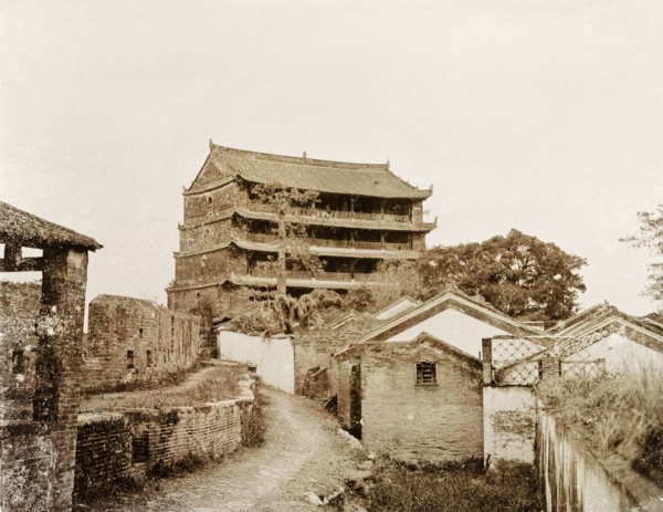 A five-storey pagoda in Canton. A five-storey pagoda stands beside the ruins of an old city wall.