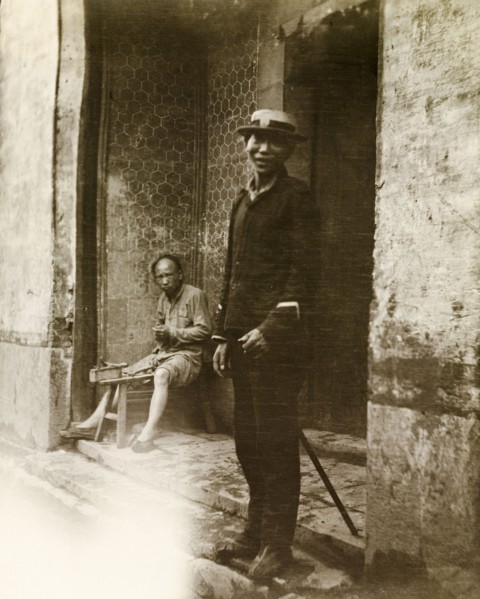 A Chinese policeman. A Chinese policeman, dressed in police uniform and a Western-style hat, smiles