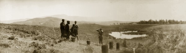 African women collecting water, South Africa. Five African women stand by pots placed on the
