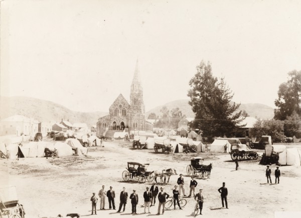 Market next to the church in Heidelberg. Tents and covered wagons wait for a market to open outside