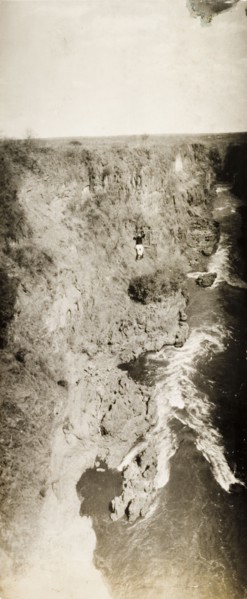 Chair lift over Victoria Falls. A lone passenger crosses the Zambezi gorge in a chair lift attached