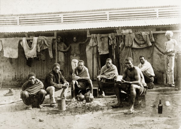 Off-duty diamond mine workers. African workers from the De Beers diamond mine rest outside their