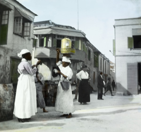 A soft drinks vendor in Barbados. A female street vendor balances a soft drinks decanter on her