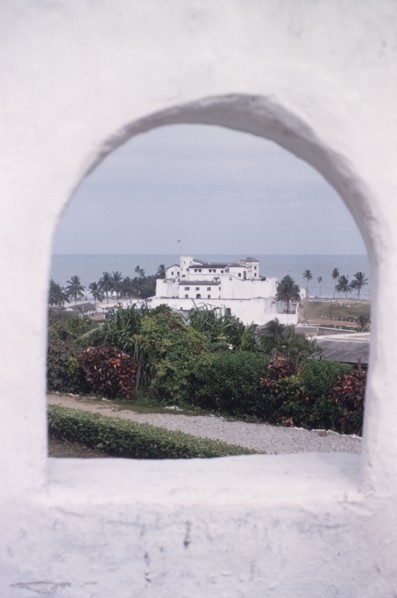 Elmina Castle from Fort St Jago. Distant view of Elmina Castle, taken through a cannon hole at Fort