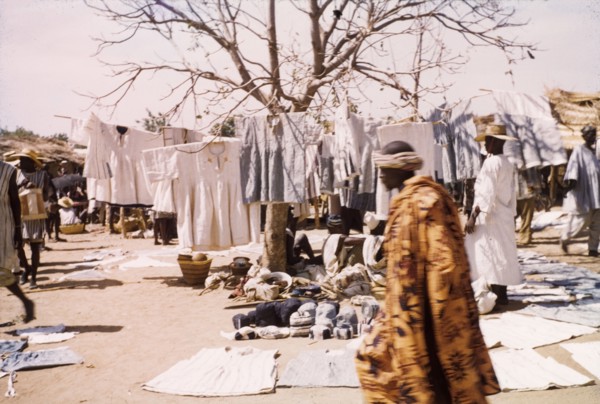 Smocks at Bolgatanga market. A range of smocks and textiles are displayed on a stall at Bolgatanga