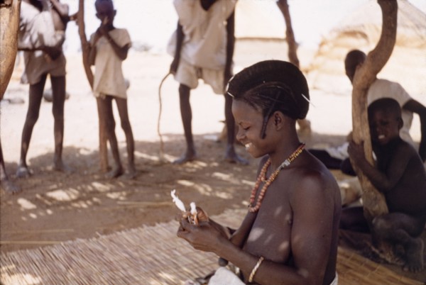 A Fulani woman uses hand spindles. A Fulani woman spins yarn using hand spindles. Kuka, Ghana,