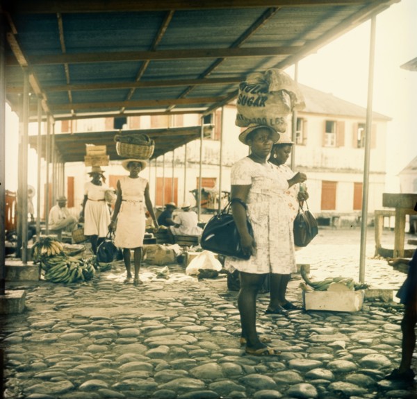 Dominican women at a street market. Dominican women at a street market carry their shopping in