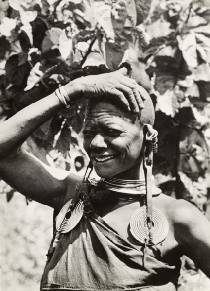 One of Chief Murigo's 19 wives'. Portrait of a Kikuyu woman, wearing several items of jewellery