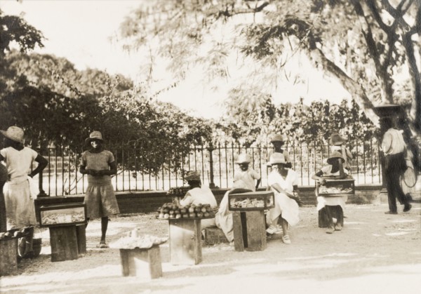 Jamaican street traders. Female street traders sell produce from trays and cases positioned on