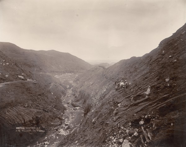 American scientists below Soufriere. American scientists stand an altitude of 610 metres (2, 000