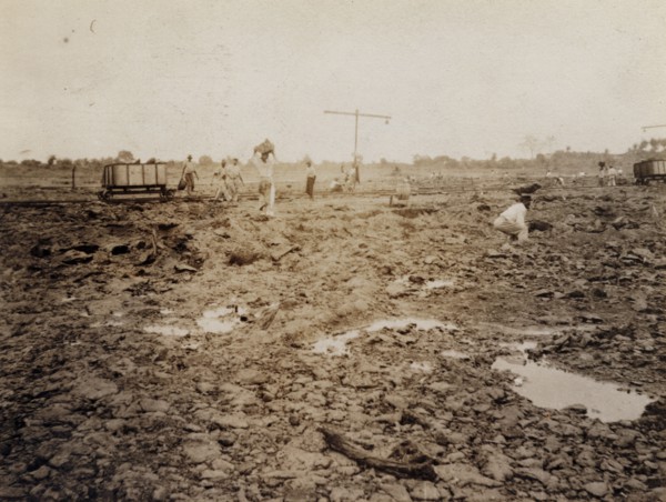 Extracting asphalt from the Pitch Lake. Labourers load lumps of asphalt extracted from Trinidad's