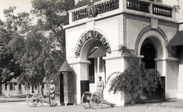 General Barracks at Panjim. Armed guards stand beside mounted artillery guns outside a 'Quartel