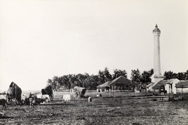 A rural landscape in Burma (Myanmar). A tall pillar-like structure, possibly a lighthouse,