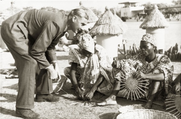 A basket-weaving demonstration. A European man visiting Kaduna Children's Village with Queen