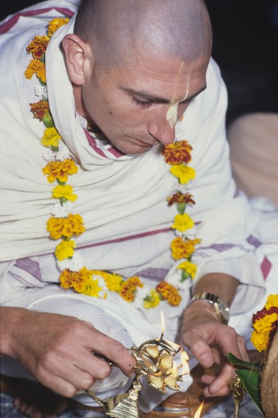 Lighting a candle for Lord Krishna. A member of the International Society for Krishna