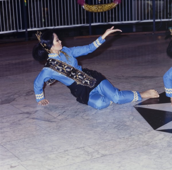Malaysian dancer at cultural festival. A female dancer in Malaysian costume performs at a cultural