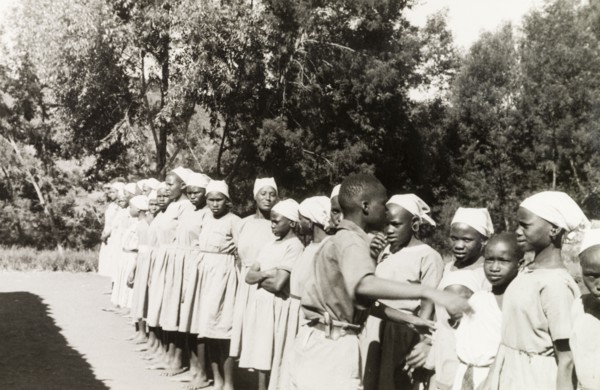 Kikuyu students at a mission school. Young Kikuyu women are lined up outdoors at the Church of