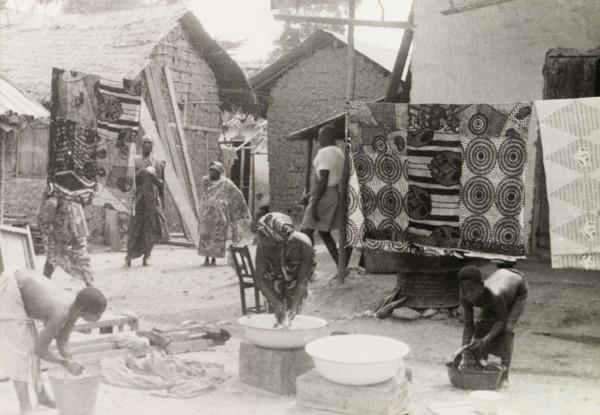 Washing day at an Asante village. Women and children wash clothes outdoors at an Asante (Ashanti)