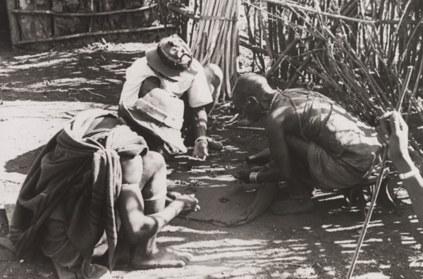 Kikuyu men reading their fortune. A group of Kikuyu men gather around to read their fortunes by