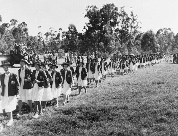 Convent schoolgirls arrive at Government House. A long line of convent schoolgirls arrive at