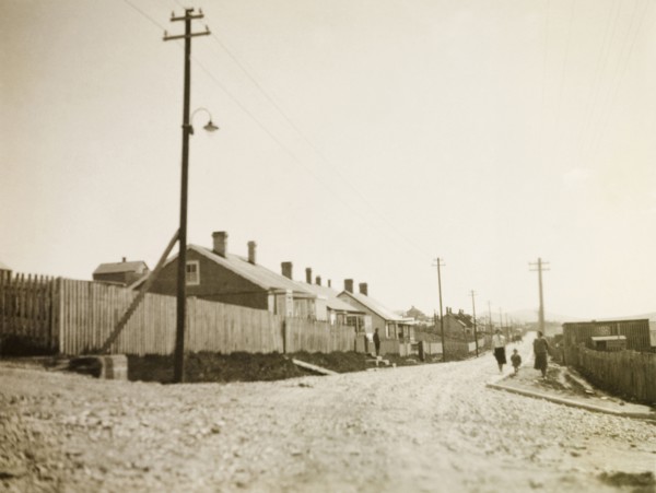 Stanley, East Falkland. View down a gravel road stretching past a row of colonial-style houses and