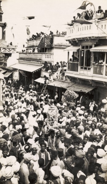 Street festival in Secunderabad. Crowds of people carry religious icons decorated with garlands as