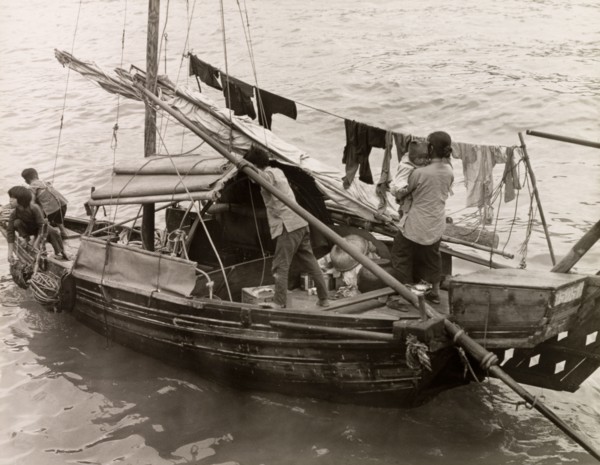 A Chinese family afloat. A Chinese family with three young children travel aboard a domestic sampan