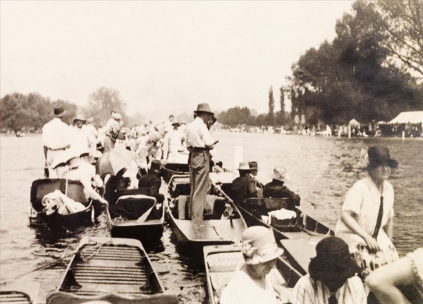 Henley Royal Regatta, 1929. Spectators gather on punts on the River Thames to watch a boat race at