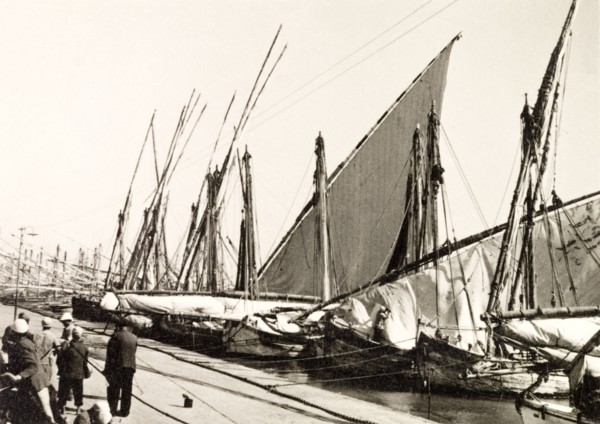 Docks on Suez Canal. Rows of sail boats are moored at docks on the Suez Canal. Suez, Egypt, 1930.