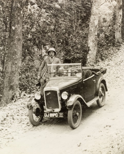 Dr Tweedie posing by his Austin 7. Dr Reid Tweedie poses by his Austin 7 car on a rural road in the