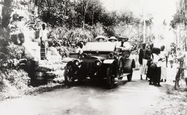 European women in convertible car, Ceylon. Three European women travel in a convertible car along a