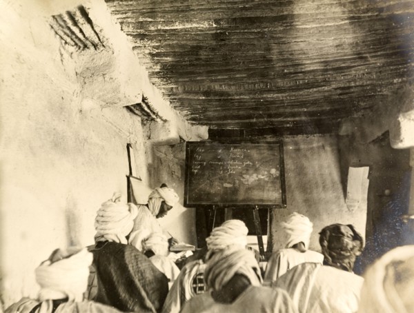Adult students in a classroom, Kano. Adult students take notes from the blackboard during a lesson