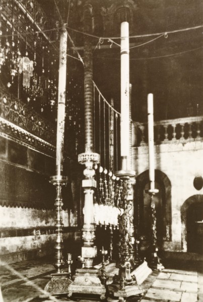 Candles in Church of the Holy Sepulchre. View of the tall, ornate candles at a shrine in the Church