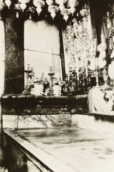 Interior of Tomb of Christ, Jerusalem. Candles line the interior of the Tomb of Christ in the