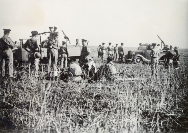 Scene of a railway incident, Lydda. British police and soldiers of the Royal Engineers gather at