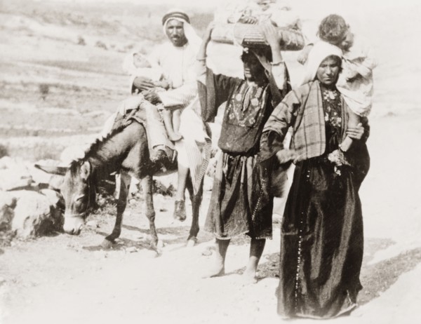 Arab family on a rural road. An Arab family travel along a rural road with two sleeping children.