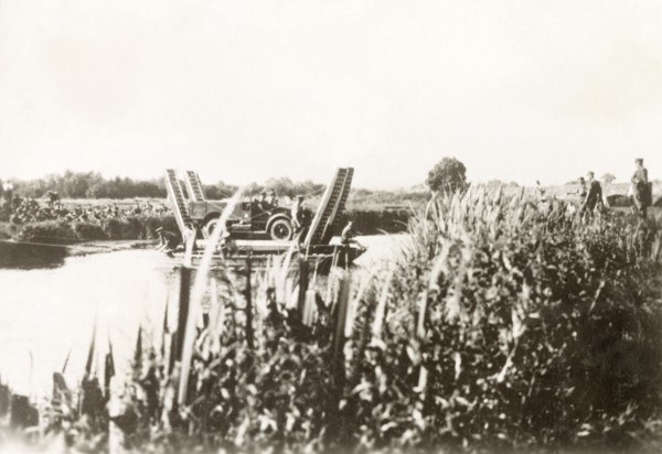 Cable ferry in Palestine. A British military vehicle is transported across a river on a cable ferry