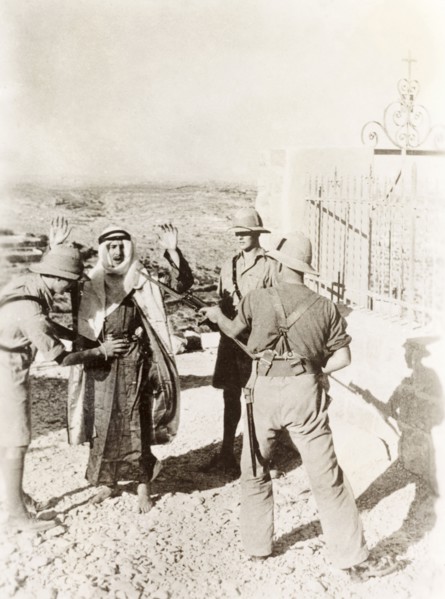 British soldiers searching a Palestinian Arab. Two British soldiers perform a body search on a