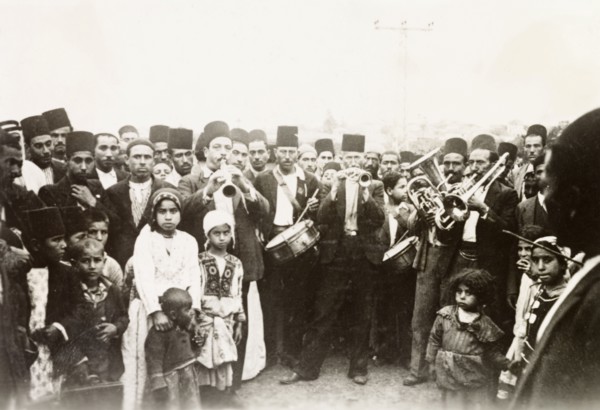 A traditional Arab wedding. Group portrait of male guests, children and musicians at a traditional