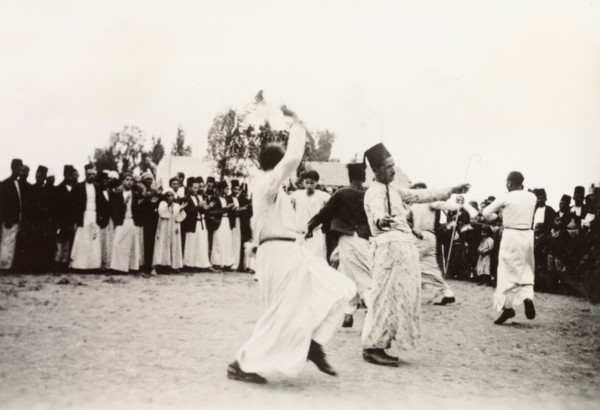 Dancing at an Arab wedding, Palestine. Several men perform a traditional dance at an Arab wedding,