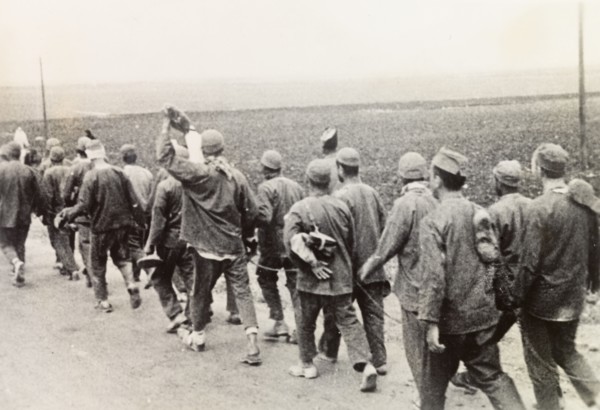 Convicts on way to work, Palestine. A chained group of Arab convicts walk along a road on their way