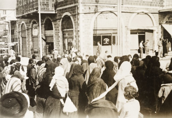 Funeral procession in Tiberias. Crowds of people take to the streets to join a funeral procession.