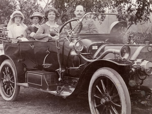Driving an Itala car, India. Three European women and their male companion take a spin in a