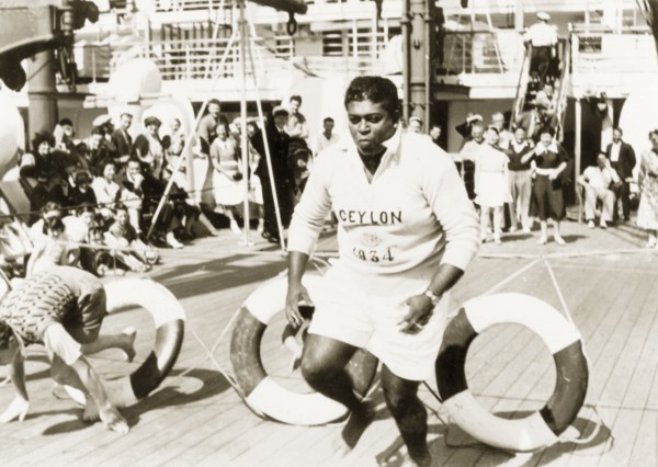 Obstacle course aboard the Otranto. Two men clamber through lifebelts as they compete in an