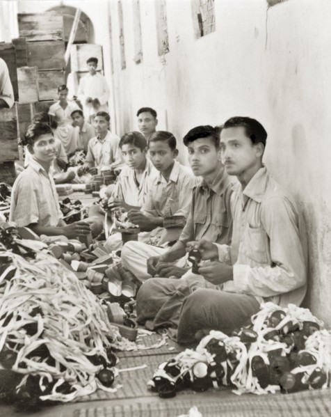 Workers in a goggle factory, Calcutta. Indian factory workers inspect and box up hundreds of pairs