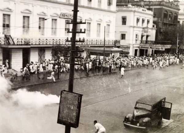 Tear gas disperses riots in Calcutta, 1946. Indian police use tear gas to disperse rioting crowds
